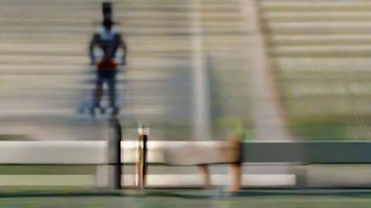 A cricketer practicing with a bat on an outfield during day training