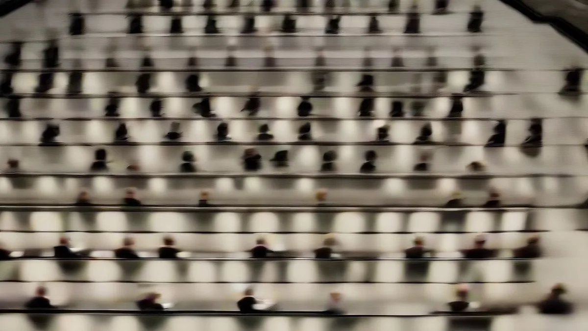Wide shot of a state legislative chamber with politicians seated at wooden desks during debate