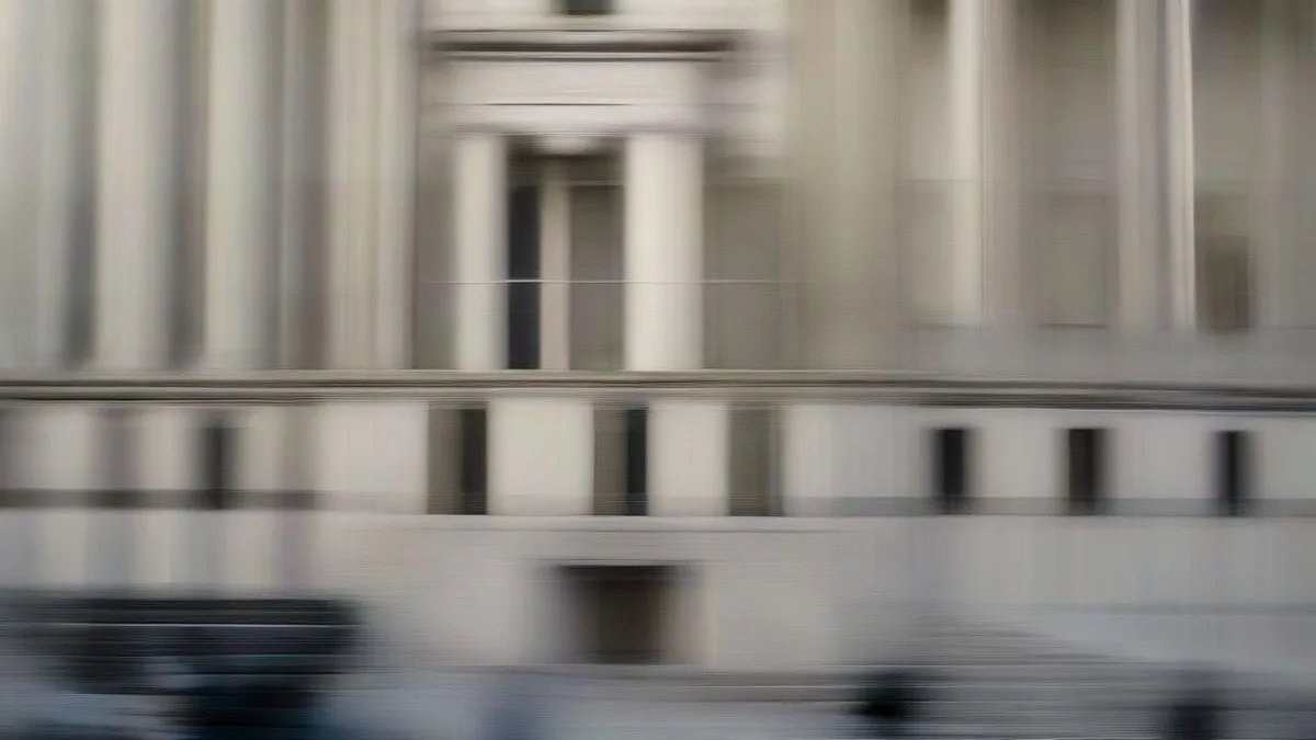 Exterior view of a grand federal courthouse building with news cameras gathered outside