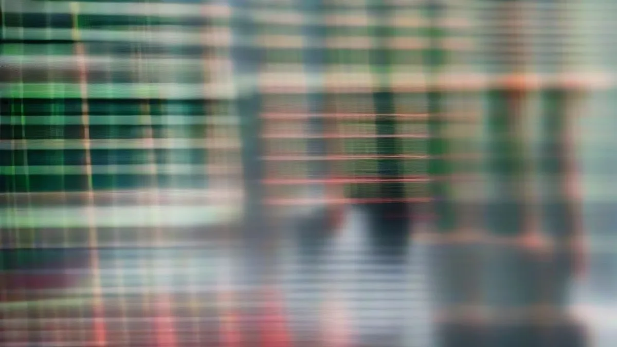 Traders at an institutional investment firm monitoring financial market movements on computer screens
