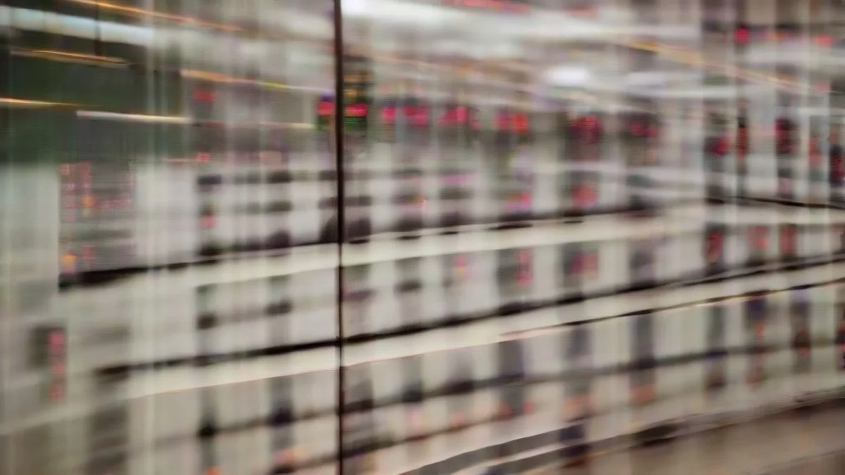 Financial market professionals working late on an institutional trading floor reviewing market movements.