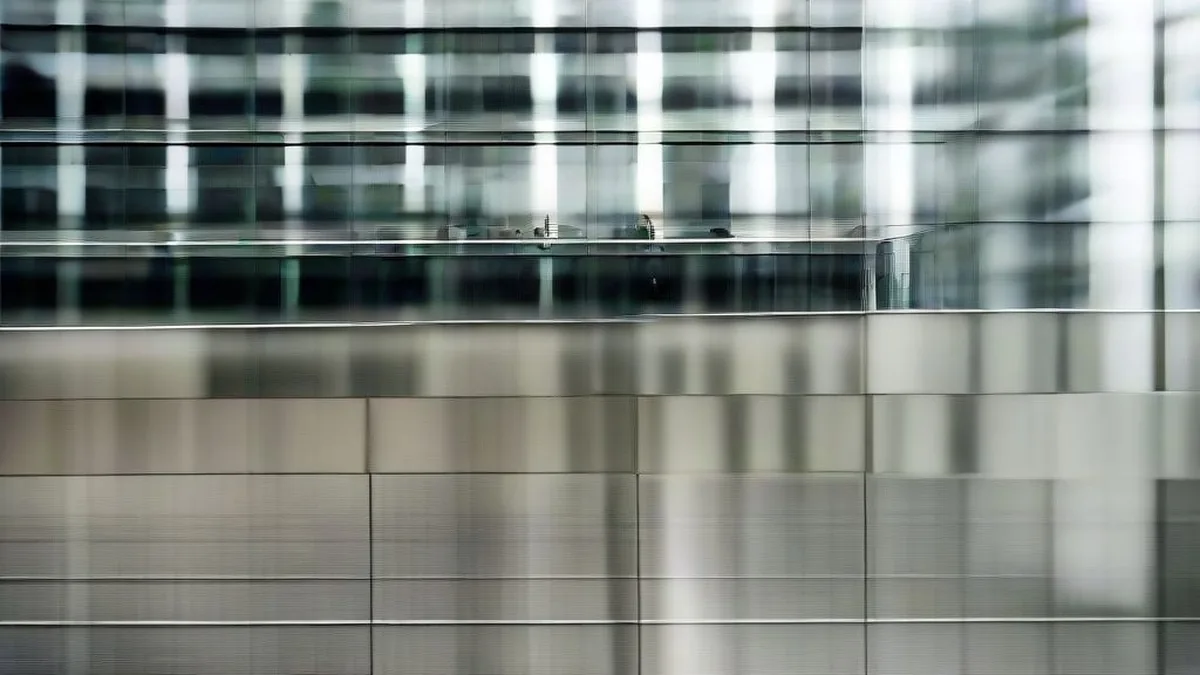 Corporate professionals walking in front of a glass modern financial headquarters building.