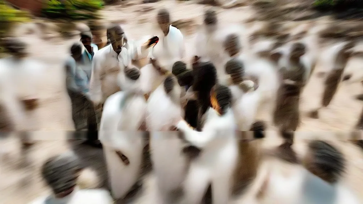 Indian political figure surrounded by journalists holding microphones during an outdoor press briefing.