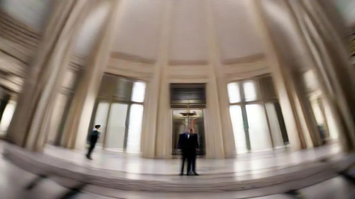 Interior of the California State Capitol building with officials and lawmakers in discussion