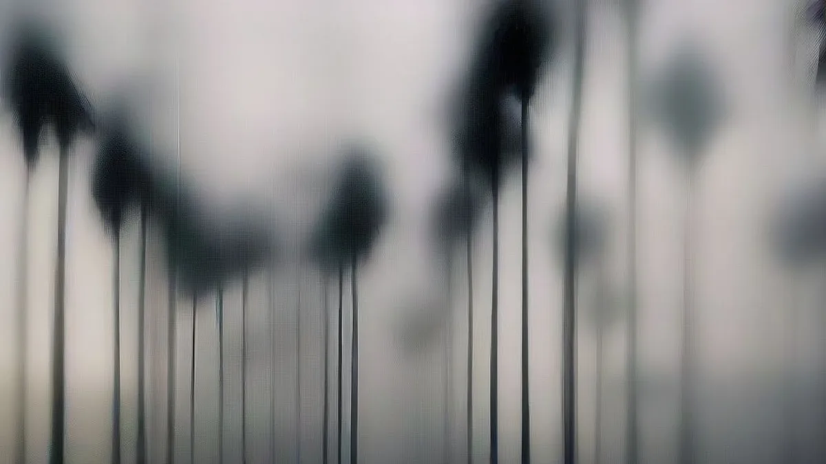 Waves crashing against sea defenses during heavy wind and dark rain clouds along coastal India
