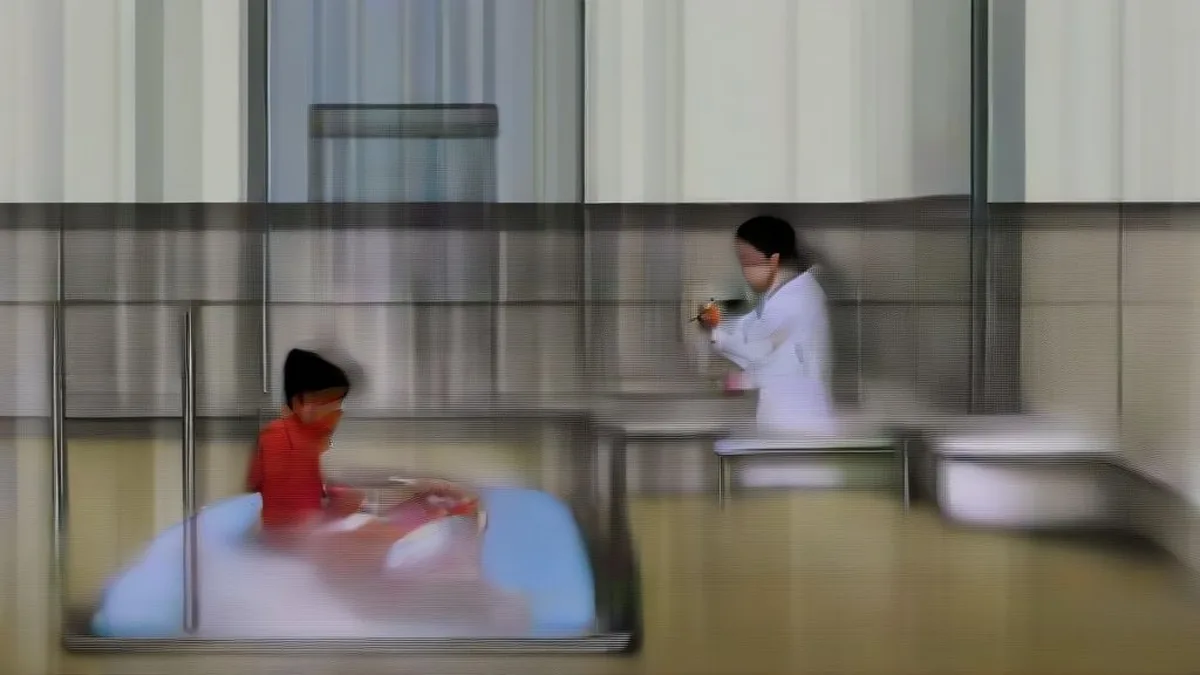 A nurse checking a student's pulse inside an Indian school medical room
