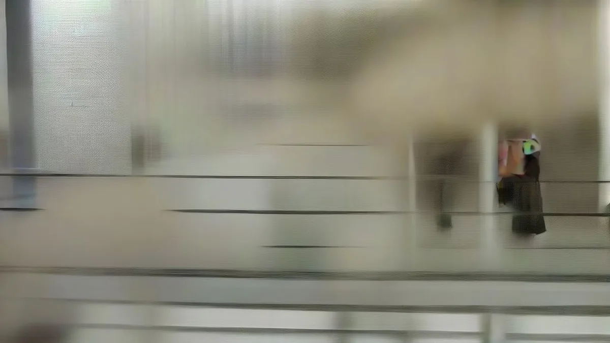 Police officers in uniform walking through an institutional hallway during an investigation.