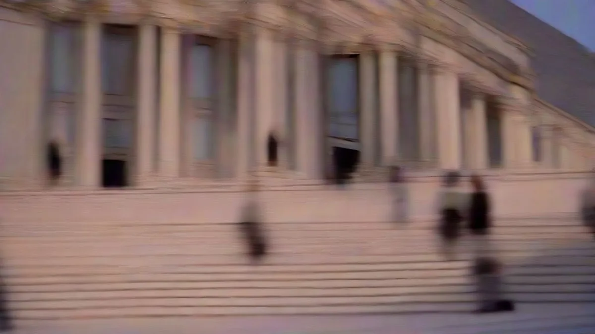 Neoclassical government building exterior at dusk with officials walking on stone steps