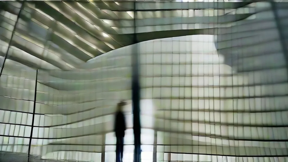 Business professionals conferring in a modern corporate banking atrium