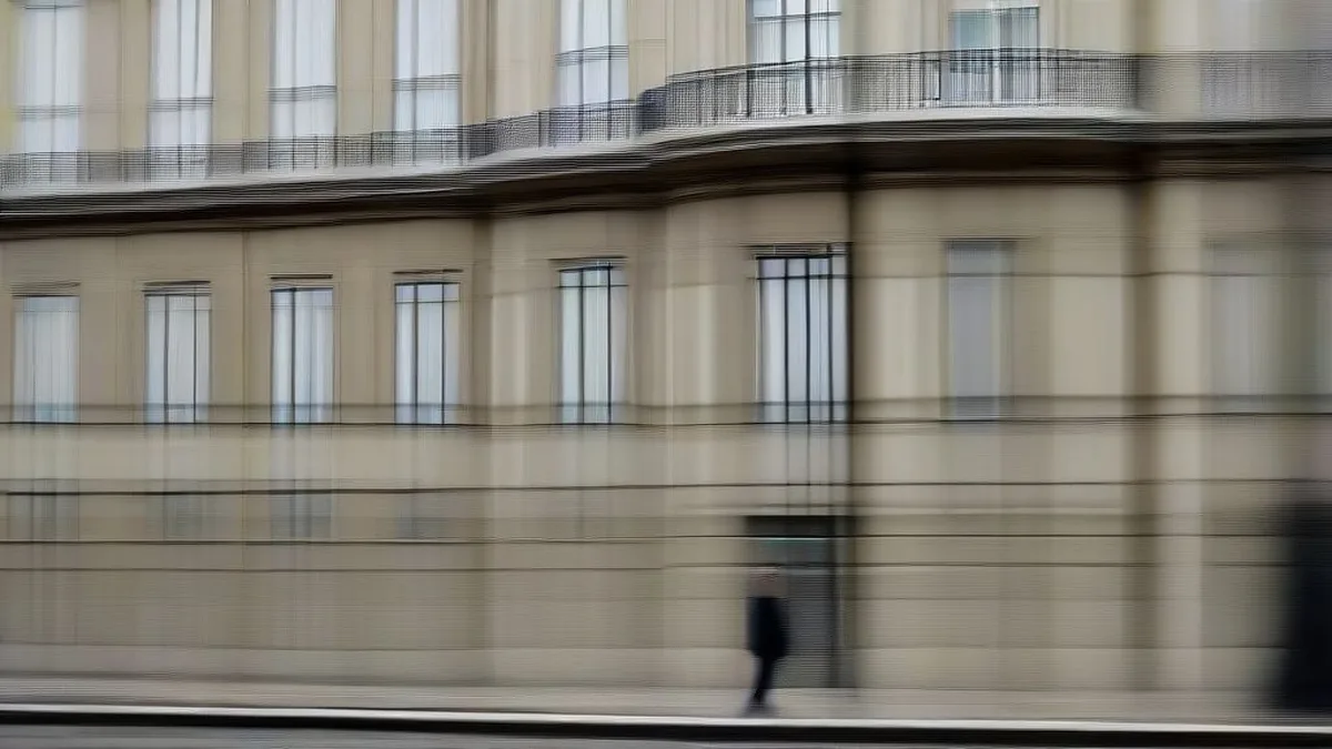 European finance official walking past a classical stone government building in Paris under overcast skies