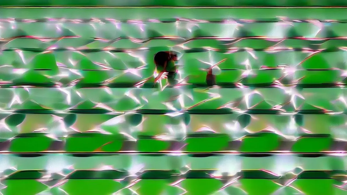 Female badminton player celebrating intensely after winning a crucial point on a green indoor court