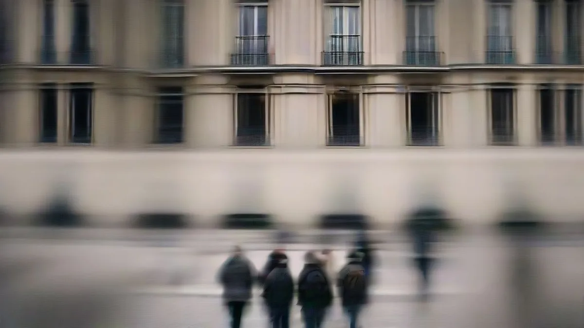 Crowd of students demonstrating along a city street during protests against French education policy reforms