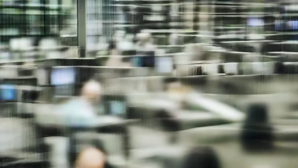 Institutional traders working at workstations on an active trading desk floor