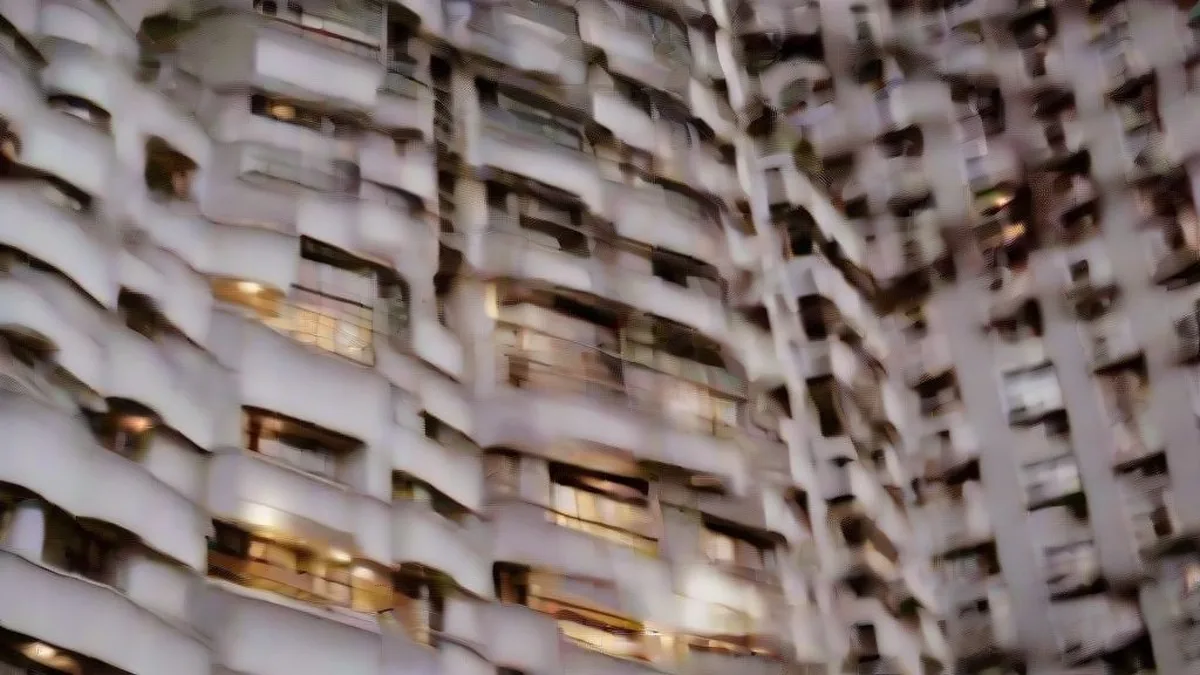 Exterior view of a residential high-rise apartment complex in Greater Noida at twilight