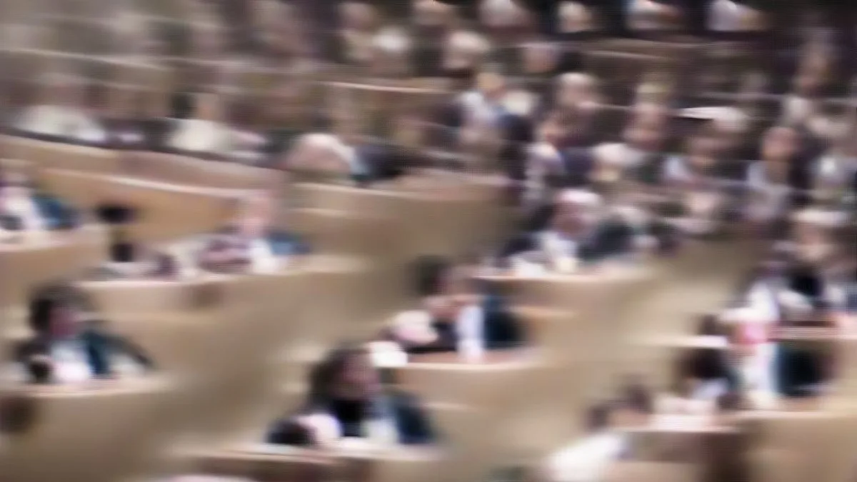 Delegates seated at an international diplomatic conference hall during official proceedings