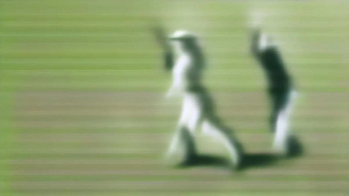Women cricketers celebrating a wicket on an outdoor cricket pitch during a match