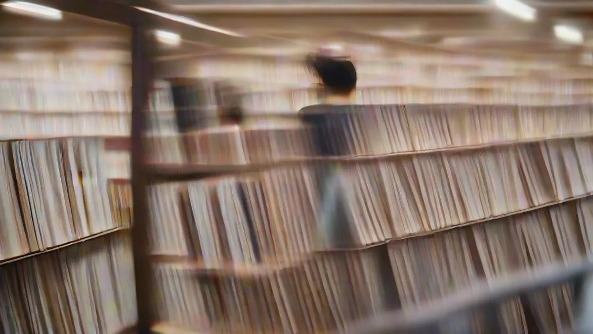 Young Indian readers browsing book collections in a modern bookstore aisle
