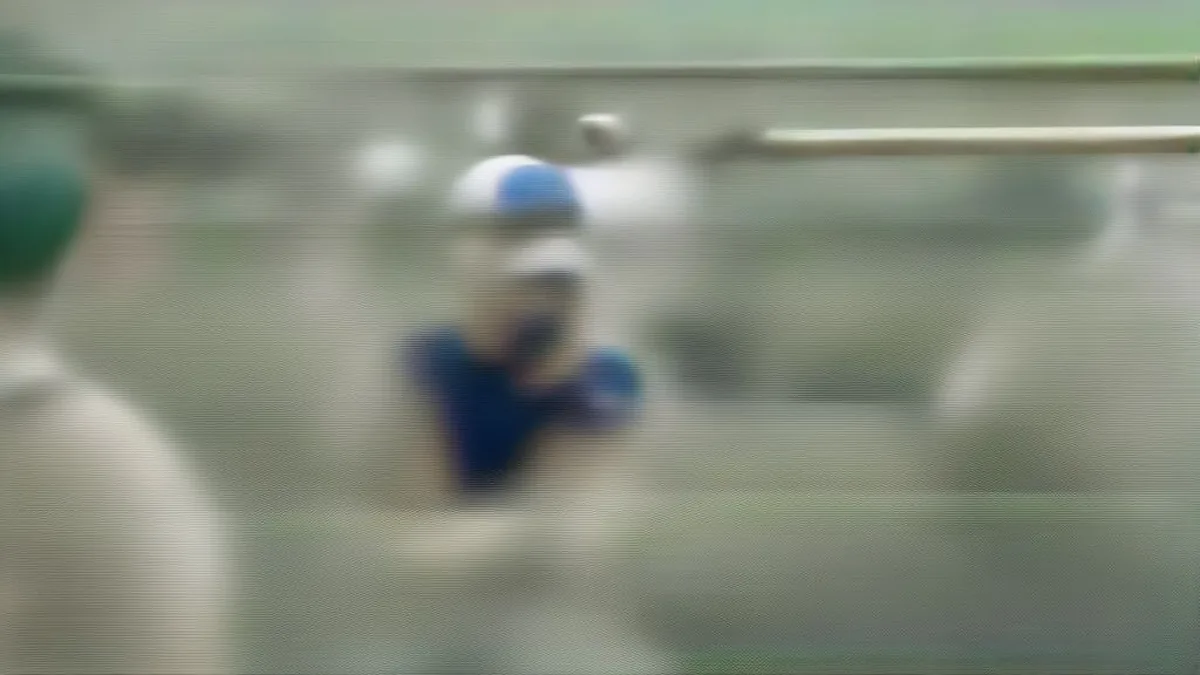 Cricket player resting near the boundary during a pre-match training session