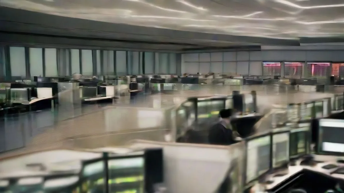 Financial traders at desks in an office in Tokyo reviewing market data across computer screens.