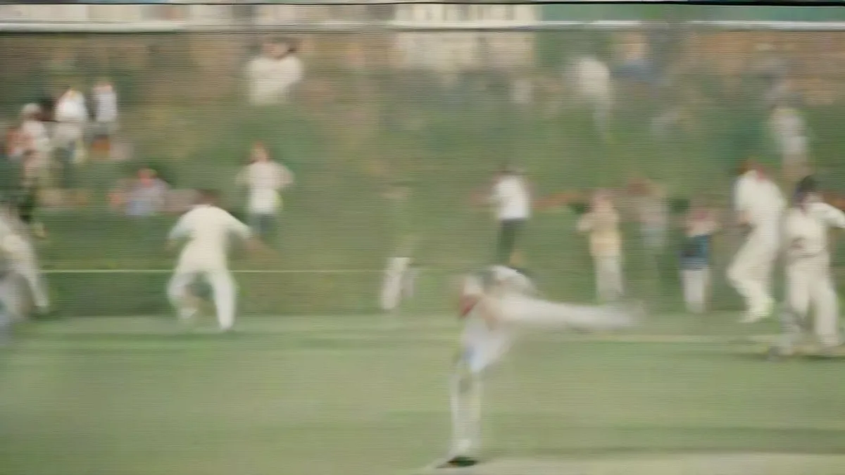 A cricket fast bowler running in to deliver the red ball during a match