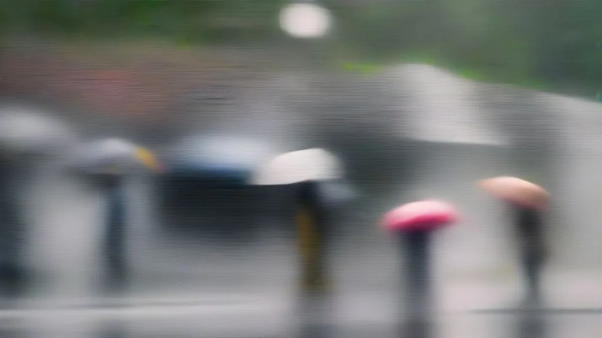 Commuters navigating a rain-soaked street in Kerala under heavy monsoon downpour with umbrellas.
