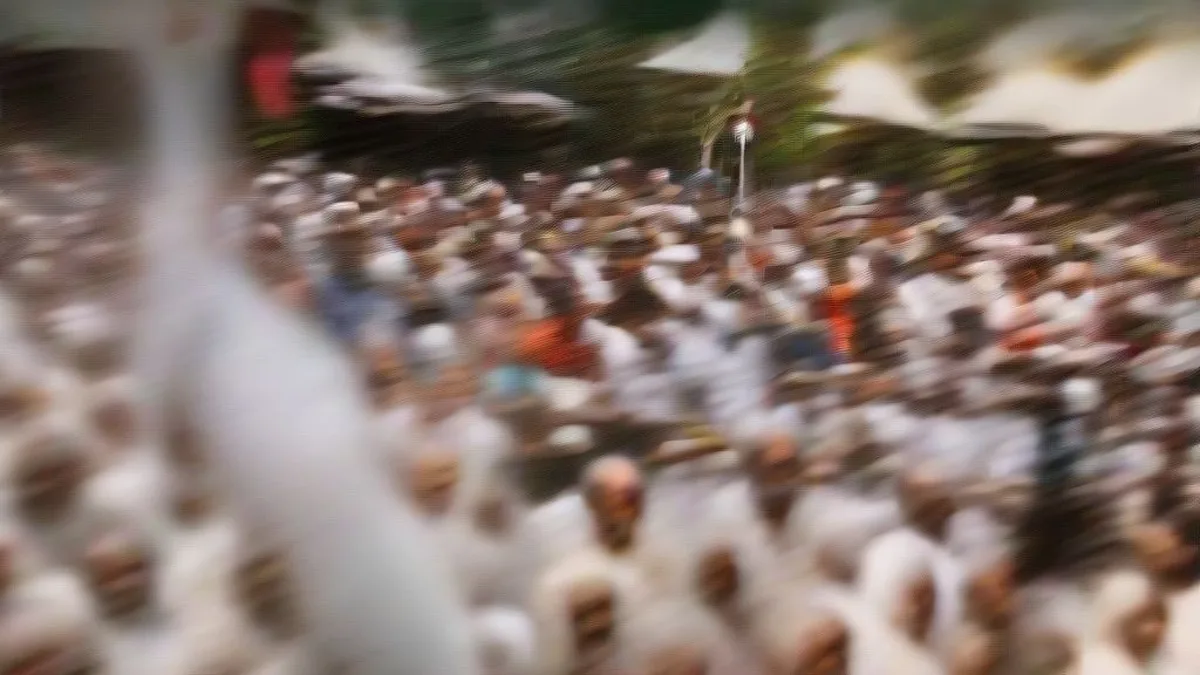 An Indian political leader addressing a large crowd from a rally lectern with microphones