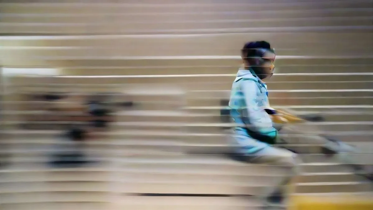 Female para-shooter competing in an indoor shooting range with focus and precision.