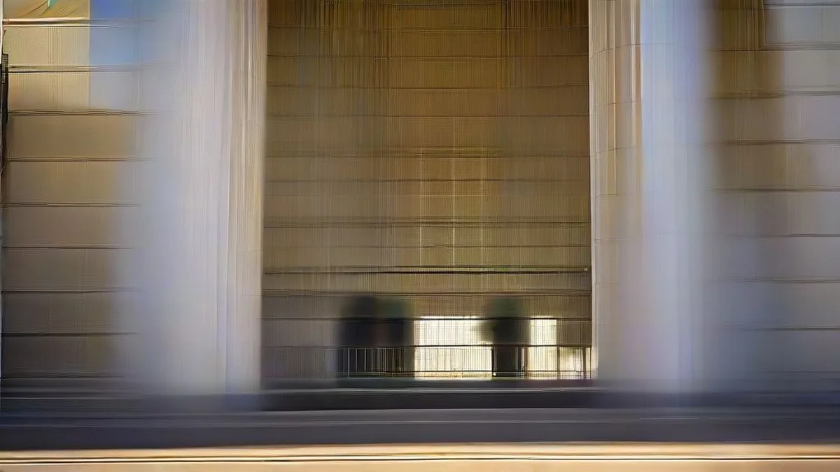 Exterior view of the neoclassical Federal Reserve building in Washington D.C. under soft morning light