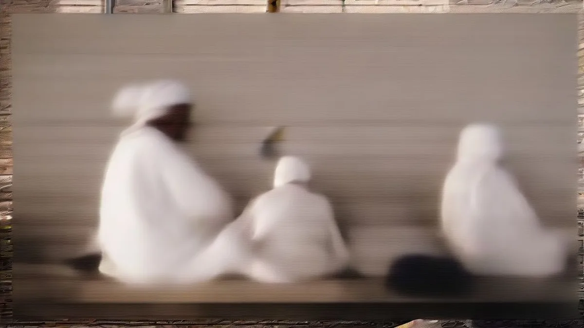 Indian pilgrims waiting with their luggage outside a terminal building in Saudi Arabia