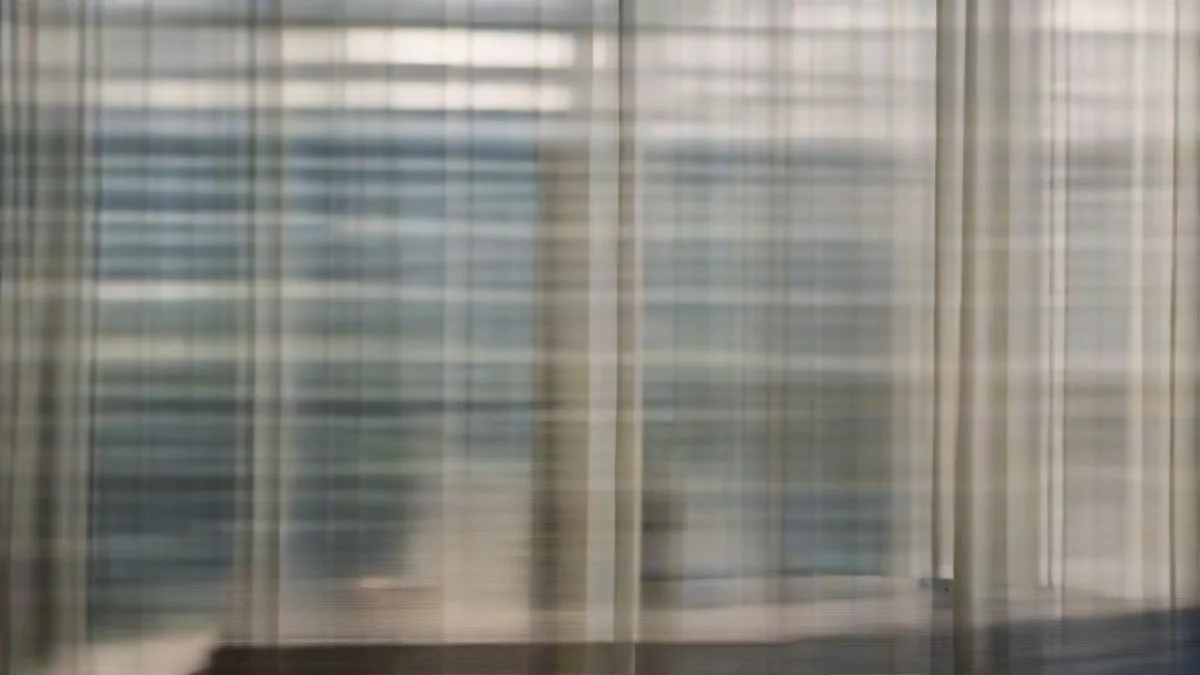 A corporate executive seated in a high-rise boardroom overlooking an evening city skyline.