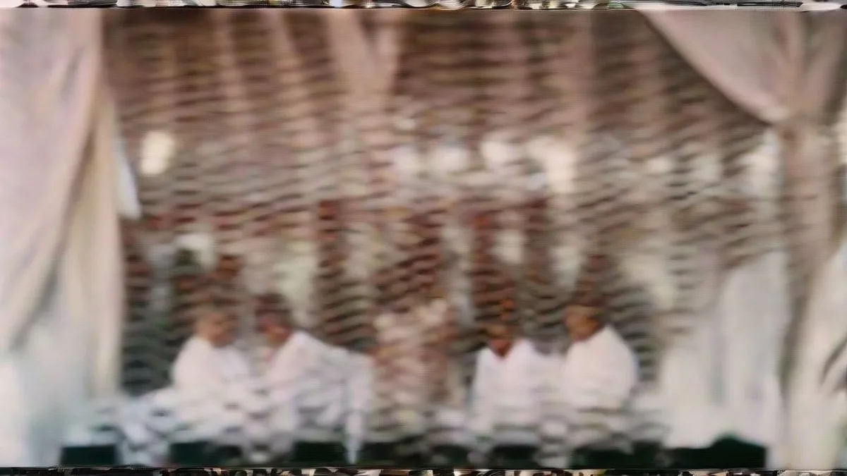 Indian political leader speaking behind microphones at a public press event