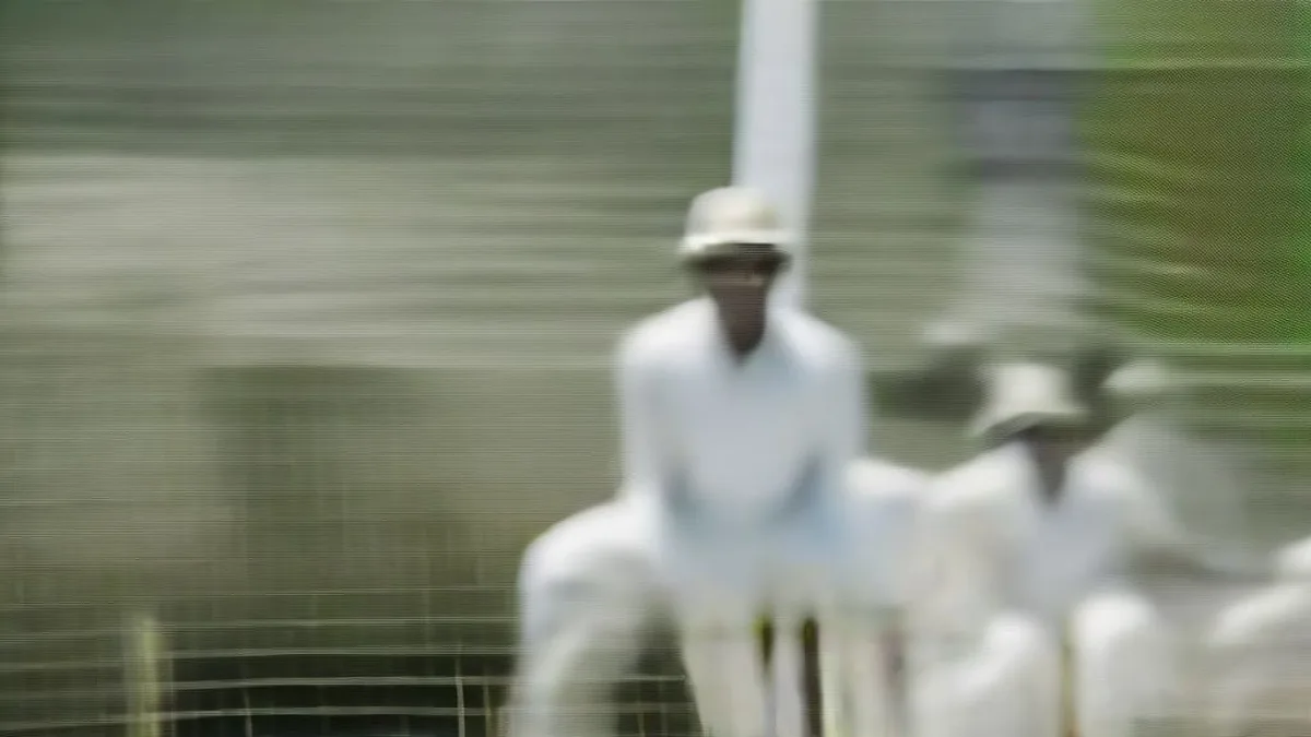 Cricket batsman in white uniform celebrating a milestone during a Ranji Trophy match