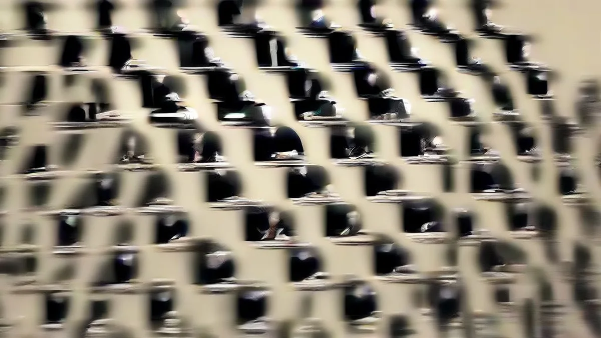 Central bank committee members seated at a wooden briefing table during a monetary policy announcement.