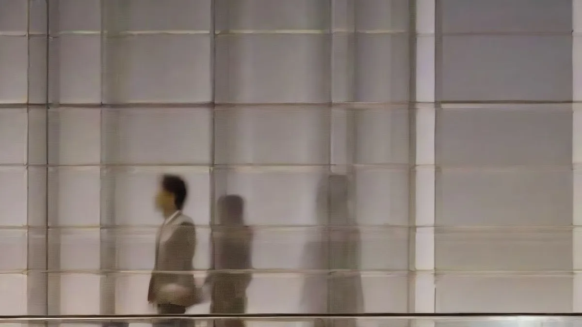 Street scene of the Singapore financial district at dusk with glass office towers and pedestrian plaza