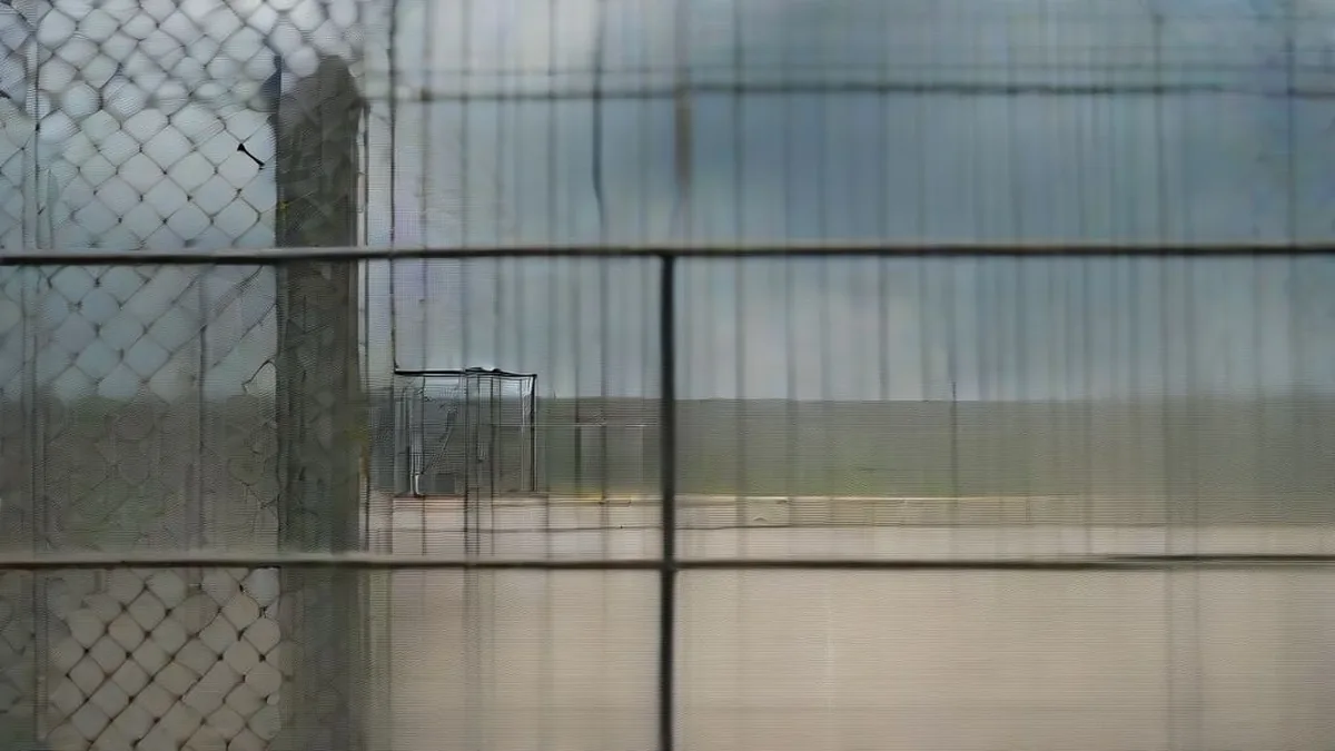 Security barriers and military installation perimeter under an overcast sky