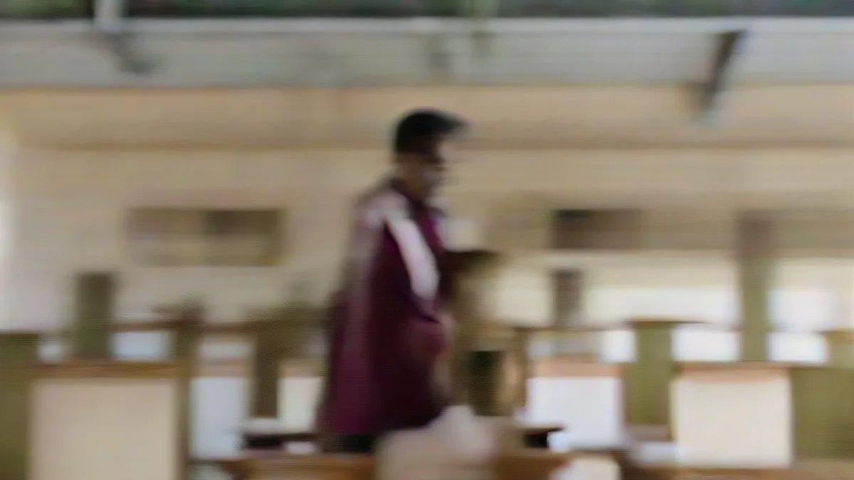An Indian male teacher instructing students in a bright secondary school classroom