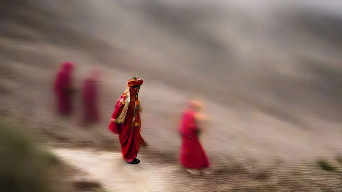 A bride in red wedding attire walks on an unpaved mountain path in Uttarakhand accompanied by relatives