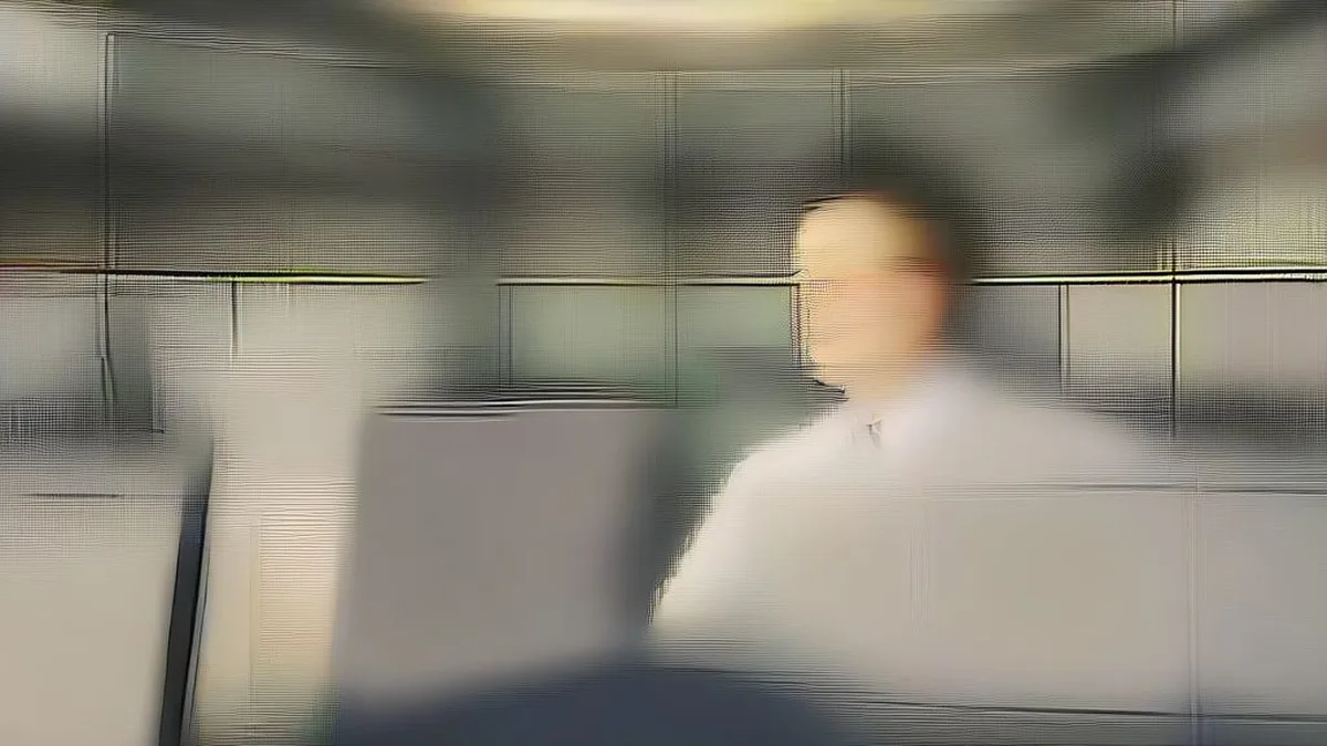 A financial trader seated at a trading desk monitoring market fluctuations across multiple monitors