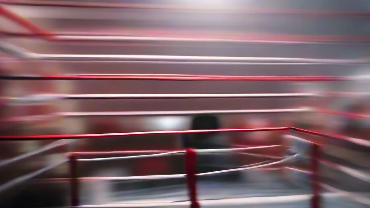 Amateur boxers competing in a high-stakes boxing ring match under bright arena lights